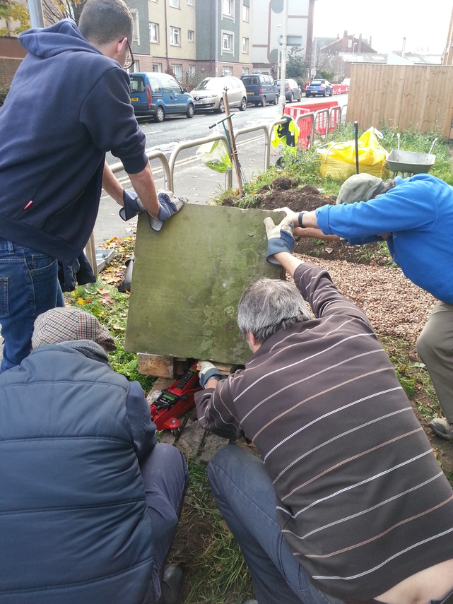 Volunteers from Goole Civic Society heave historic school stone into position