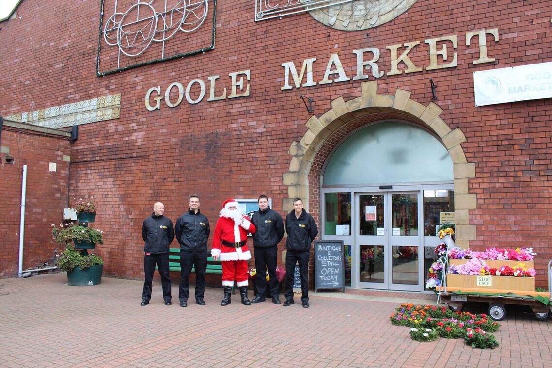Santa arrives at Goole Market flanked by firemen