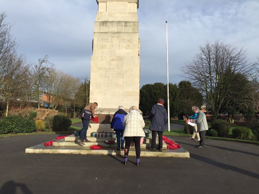 Goole volunteers survey the town's cenotaph as part of a Civic Voice training workshop